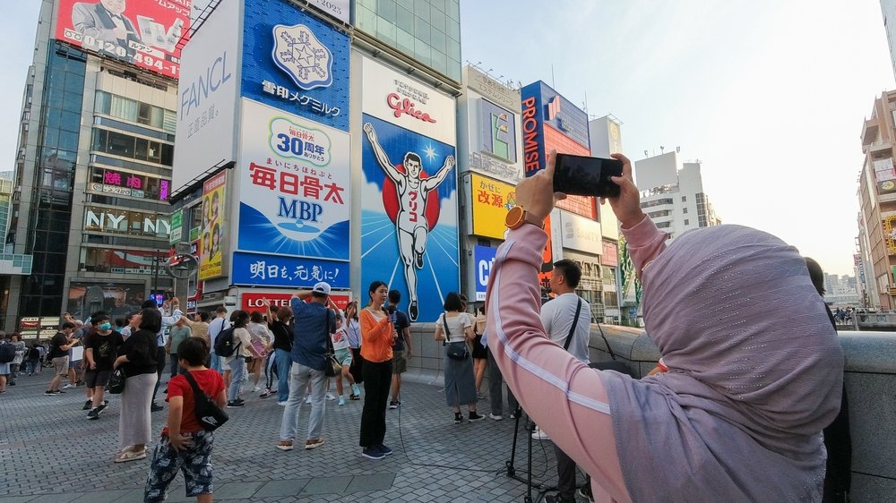 Large digital billboard district with the Glico Running Man sign in Osaka